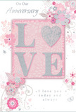 This anniversary card offers a gentle, romantic atmosphere, combining soft pastel pinks and silvery greys in a way that evokes a tranquil evening sky above Harrow on the Hill. The centrepoint is the word LOVE, artistically formed in raised, soft glitter so that it gleams but never overwhelms the design. The letter O is transformed into a shimmering silver heart, textured to catch the light like polished petals under lamplight near the High Street. Around this focal word, delicate blooms in blush and mauve unfurl with a dreamy, watercolour softness, their edges and veins defined by the lightest strokes of grey and white. The flowers seem to drift outward, much like the gentle spread of a bouquet carefully arranged by a local florist for an anniversary dinner at home. Fine swirls, airy petals, and tiny butterfly motifs weave through the design, adding a sense of motion and playful romance, reminiscent of an English spring garden after a light rain. Each line and curve feels precise yet effortless, as if sketched from life in one of the nearby green spaces. The inscriptions On Our Anniversary and I love you today and always are set in elegant, flowing script that mirrors the soft arcs of the vines and stems, lending the design a feeling of calm sincerity. Overall, the card appears like a keepsake meant to be treasured - a visual whisper of enduring affection, perfectly suited to mark a shared journey for couples across Harrow on the Hill who value tenderness and thoughtful details.